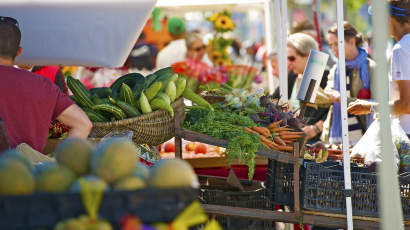 Shoppers at an outdoor farmers' market.