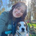 AnimalKind trainer Emily Westfall of Epsilon Dog Training with her dog at a park