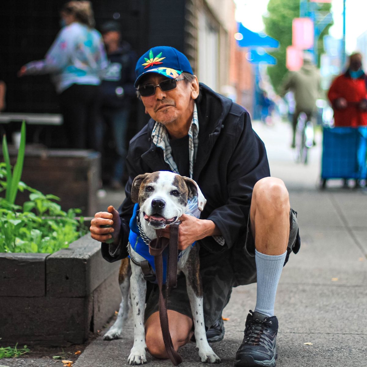 Vernon with Maya the dog on the street.