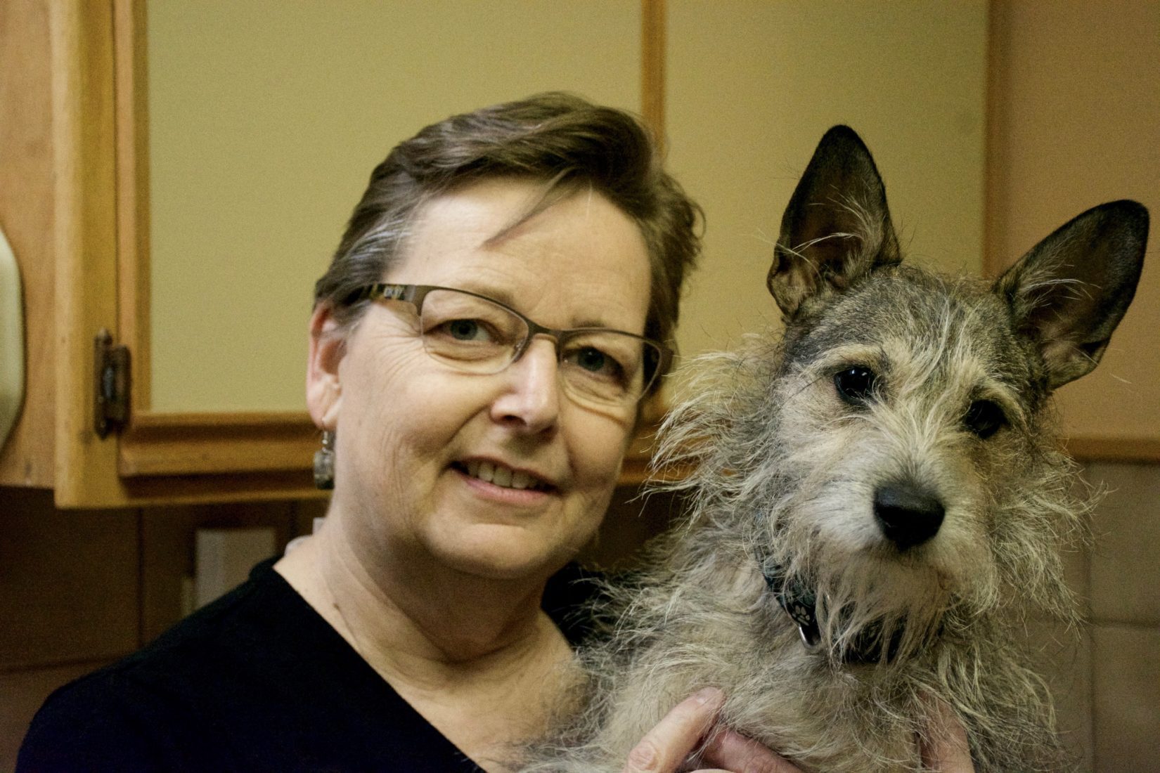 Dr. Holly Tillotson poses with a dog for a photo