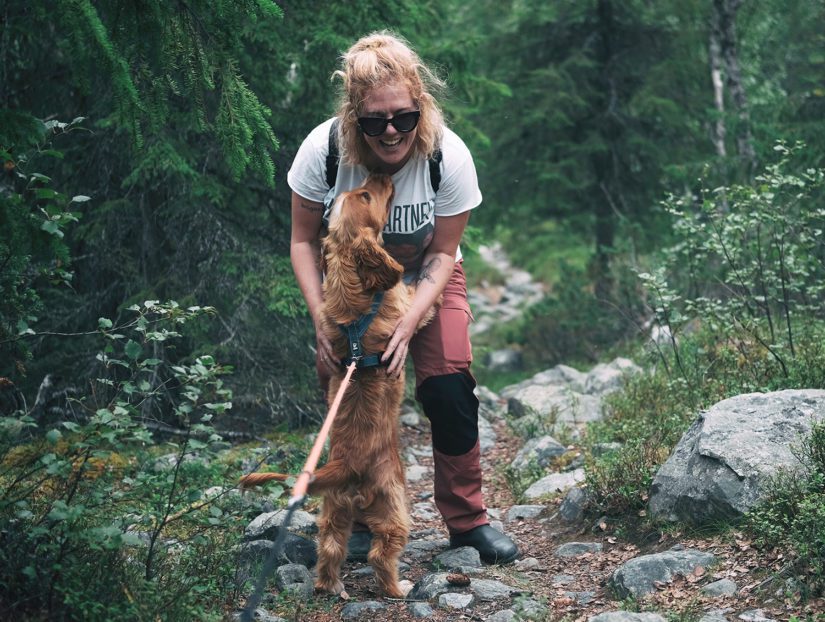 woman hiking outside with dog