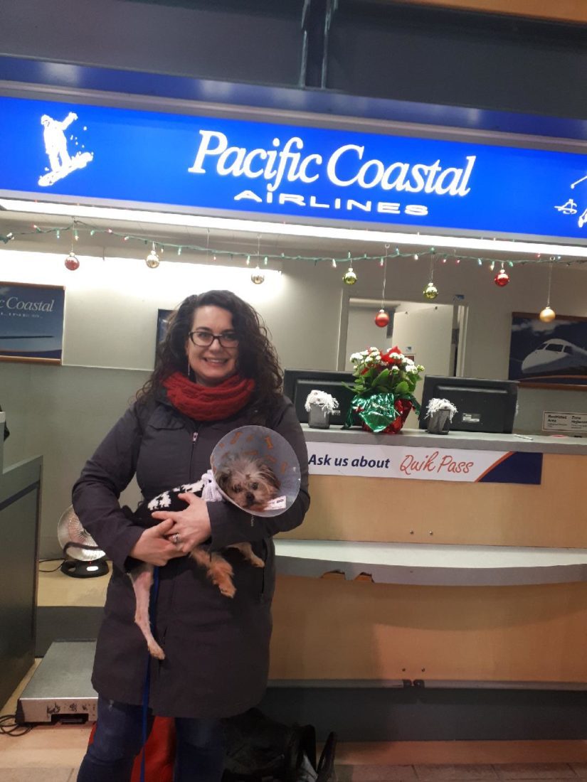 Noel and one of our SPCA volunteers standing in front of the Pacific Coastal Airlines ticketing booth 
