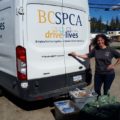 Victoria Olynik outside truck with pet food bank