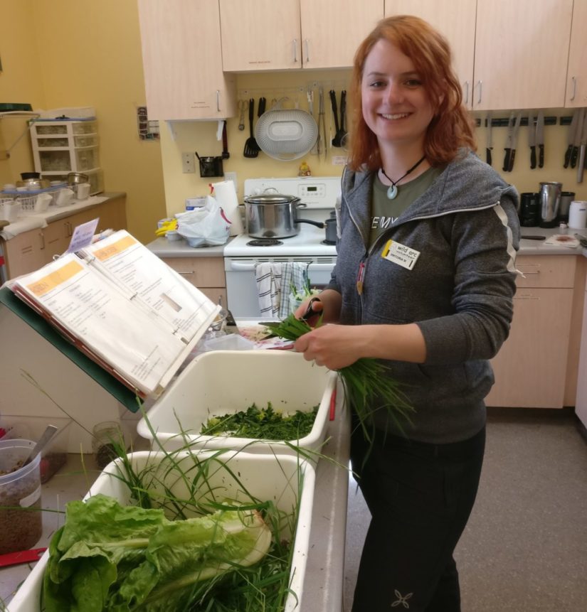 Woman preparing greens for patients at Wild ARC